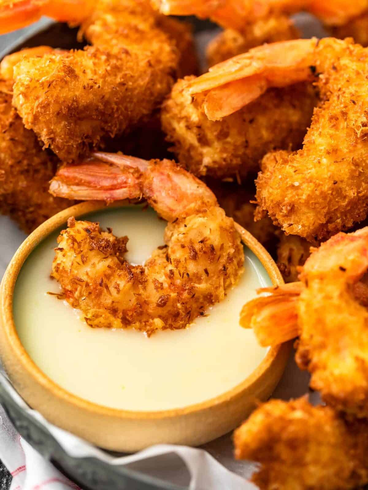Coconut Shrimp is a crispy, crave-worthy appetizer that everyone will love. It's especially delicious when paired with the perfect coconut shrimp sauce: a Spicy Pina Colada Dipping Sauce! The two go hand in hand, a match made in heaven. And this coconut shrimp recipe is just as good as a main dish as it is as a party appetizer!