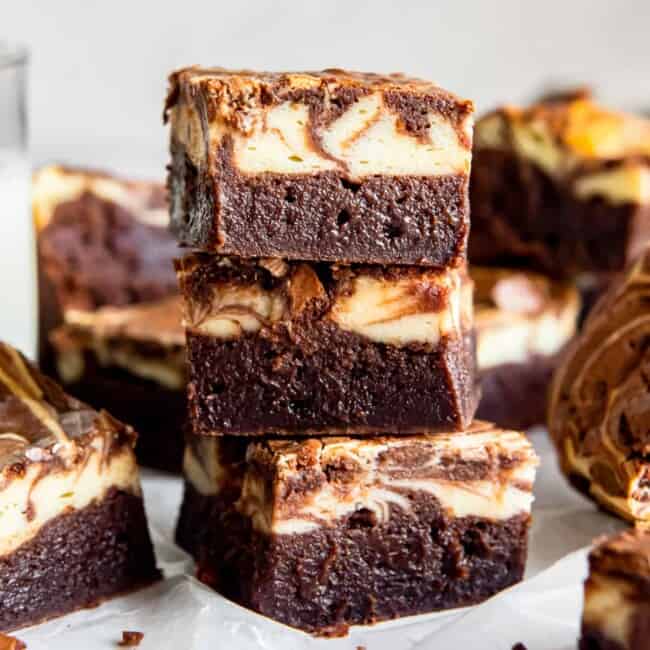 side view of 3 stacked cream cheese brownies.