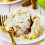 apple cinnamon rolls with icing on a plate.