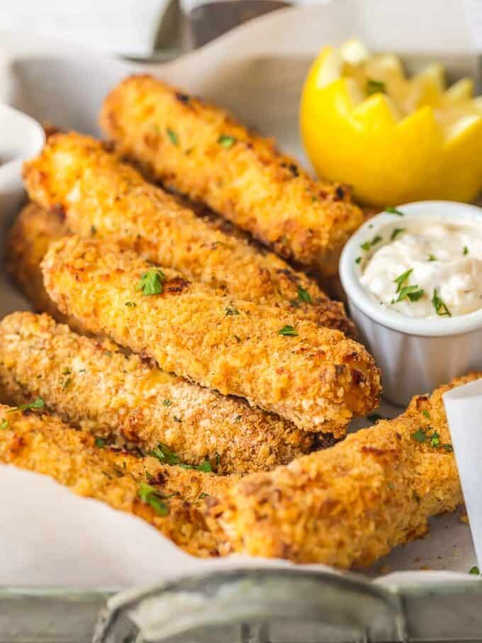 This homemade FISH STICKS recipe is baked instead of fried, making them crispy, tender, & flaky. These baked fish sticks aren't complete without homemade tartar sauce! Homemade fish sticks recipe with a side of tartar sauce
