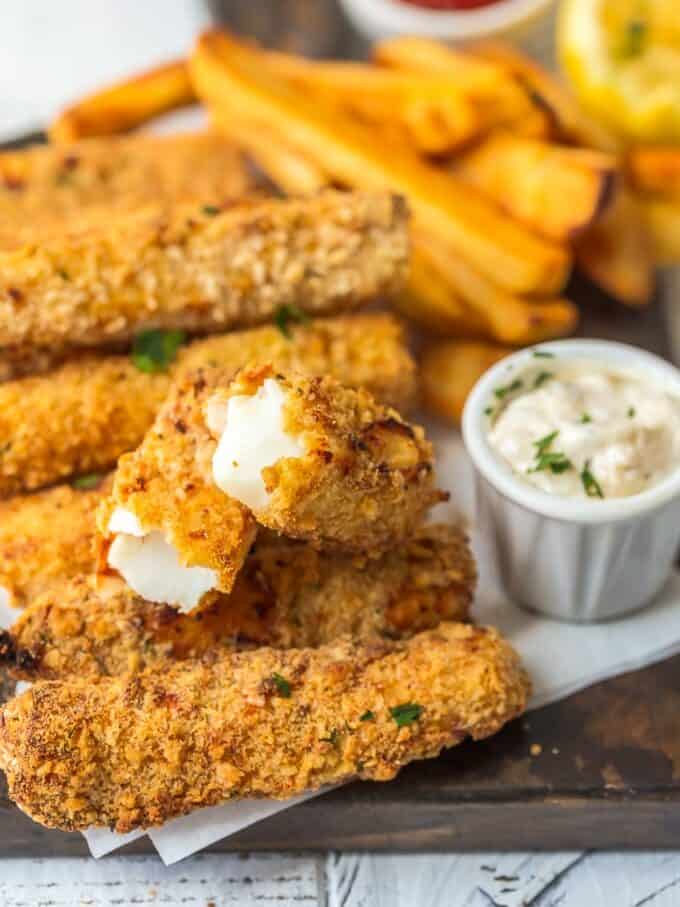 This homemade FISH STICKS recipe is baked instead of fried, making them crispy, tender, & flaky. These baked fish sticks aren't complete without homemade tartar sauce! Fish sticks and fries