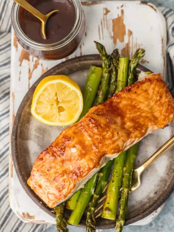 overhead view of glazed salmon on a plate of asparagus