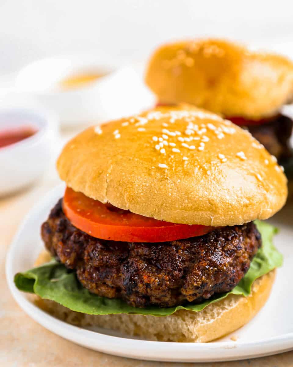 a plate with two burgers on it.