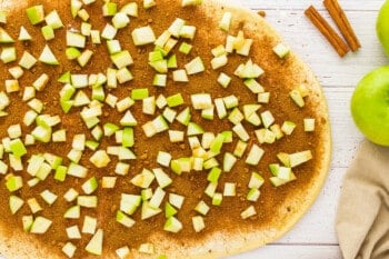 a pizza with apples and cinnamon on top.