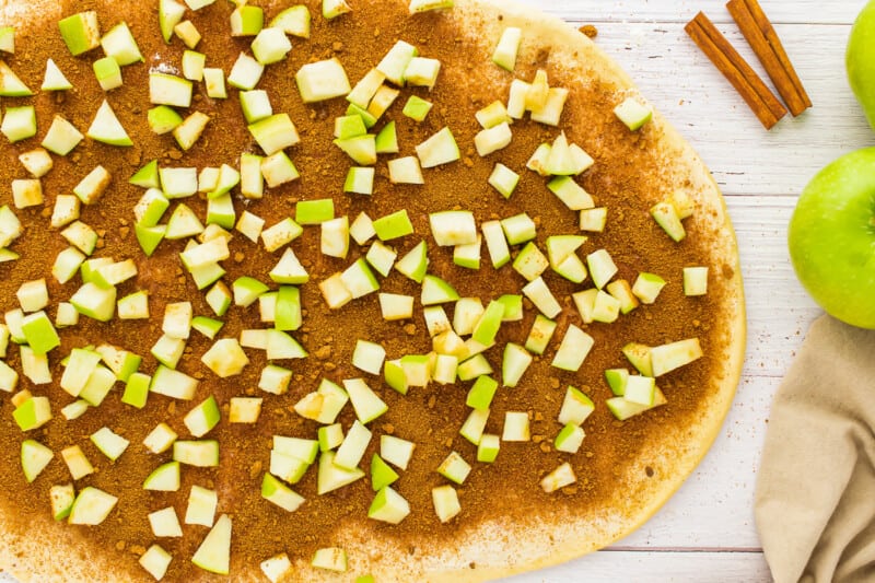 a pizza with apples and cinnamon on top.