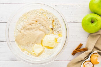 a bowl of oatmeal with apples, cinnamon and butter.