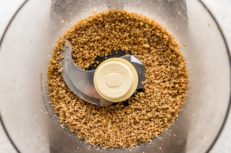 a food processor filled with granola.