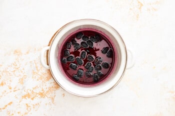macerated blackberries in a white bowl.