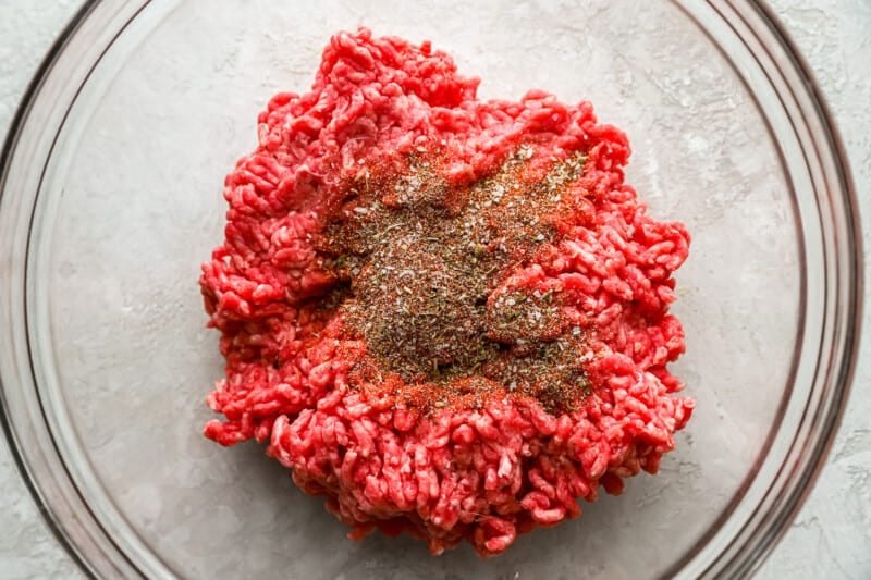 a bowl of ground beef with spices in it.