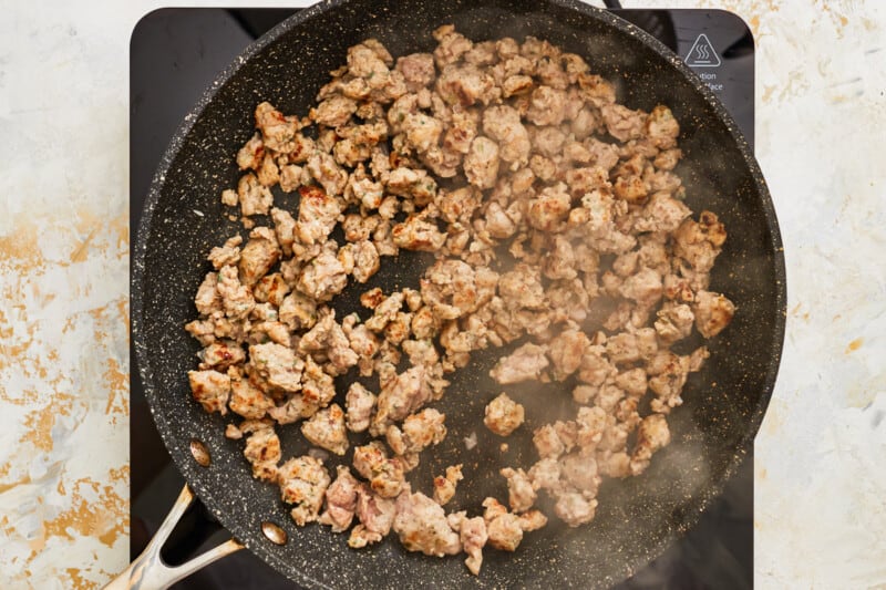 sausage browning in a skillet.