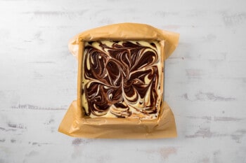 swirled cream cheese mixture and brownie batter in a square pan.