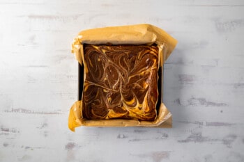 baked cream cheese brownies in a square pan.