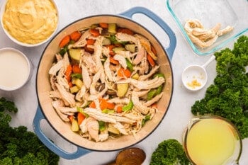 chicken and kale in a pan with a bowl of kale.