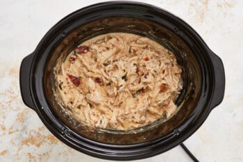 shredded crockpot alfredo chicken in a crockpot.