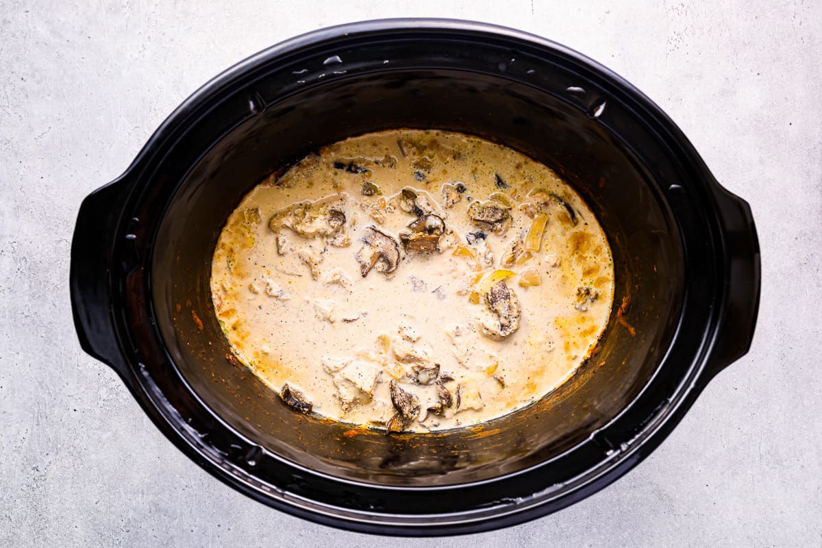 Chicken tetrazzini in the crockpot with melted mozzarella cheese.
