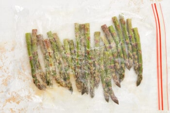 marinating asparagus spears in a ziplock bag.