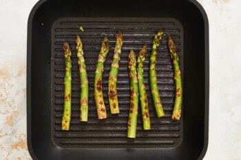 grilled asparagus spears on a grill pan.