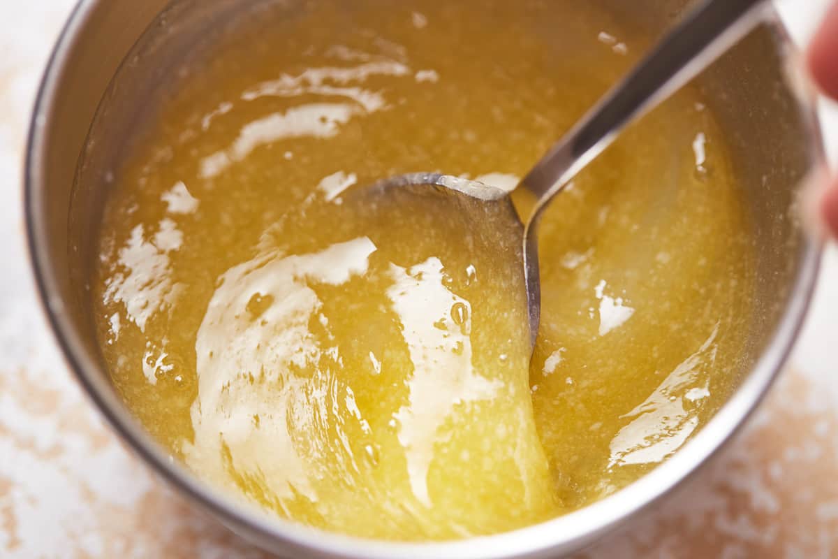Lemon juice and butter mixed in a stainless bowl.