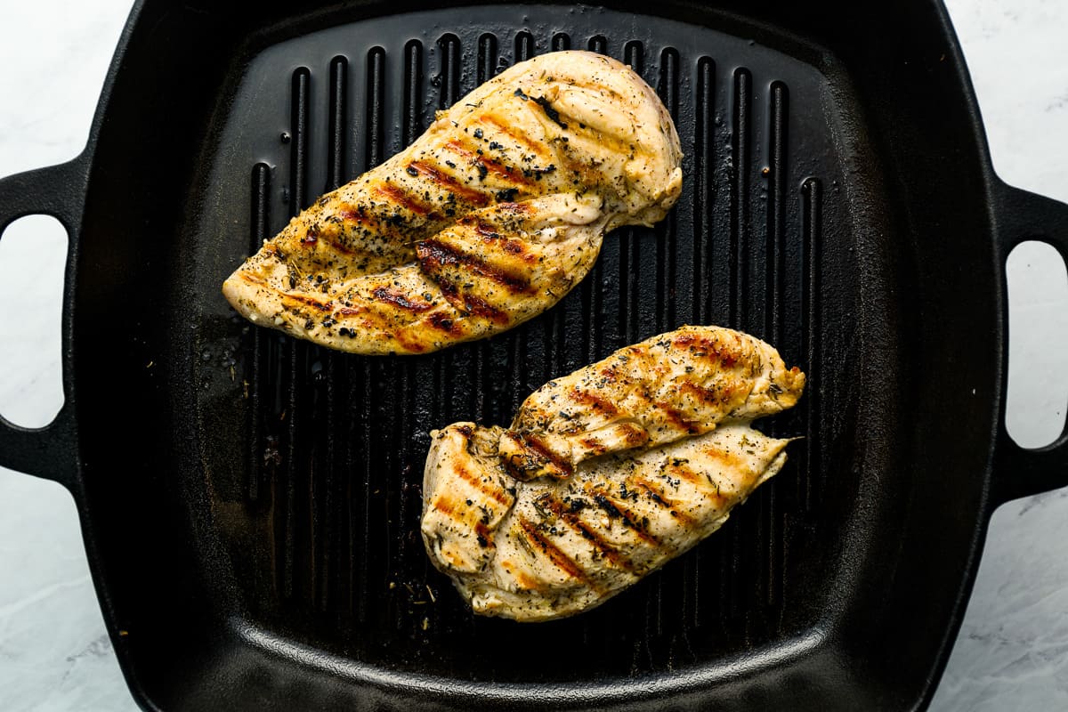 grilled chicken breasts on a grill pan.