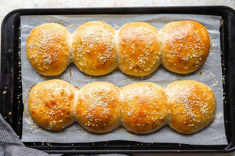 sesame buns on a baking sheet.