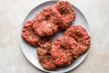 beef burgers on a white plate.