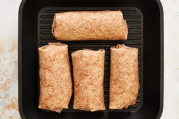 4 chicken ranch wraps on a grill pan.