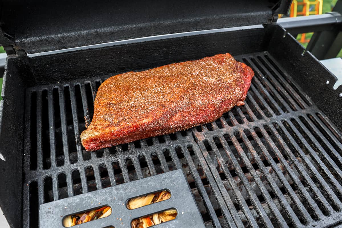 Seasoned brisket on a grill.