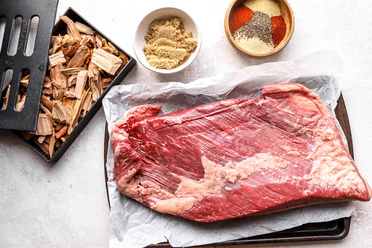 Ingredients and tools to make smoked brisket.