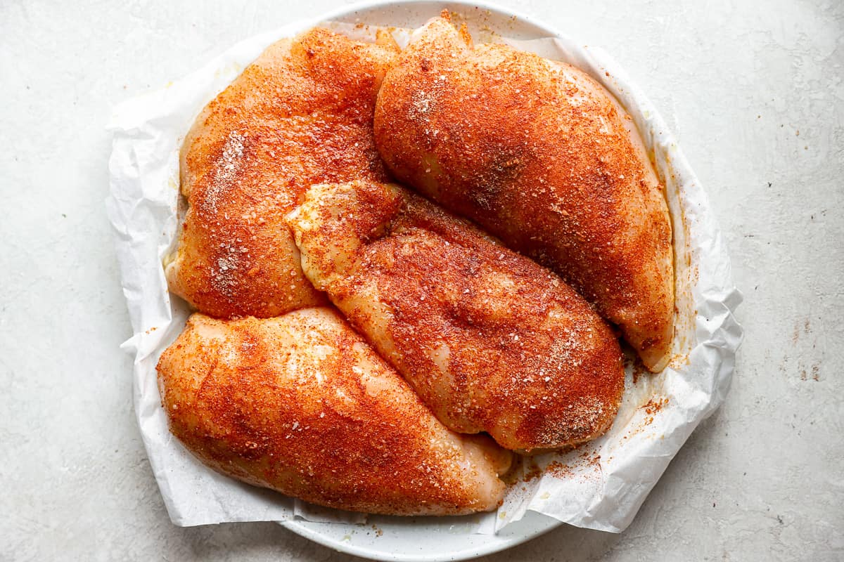 roasted chicken breasts on a white plate.