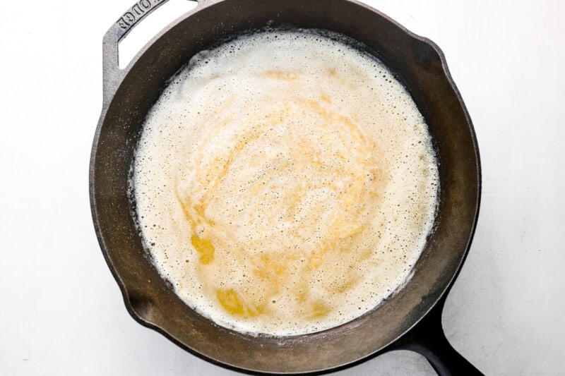 spices added to butter and flour in a cast iron pan.