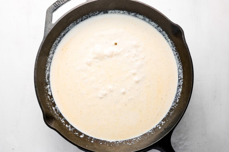 half-and-half added to butter and flour roux in a cast iron pan.