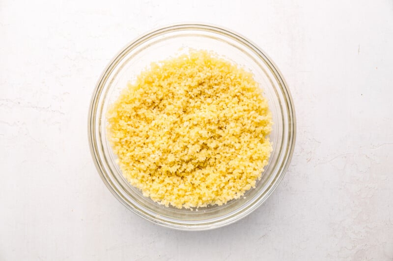 panko breadcrumbs and butter mixed together in a glass bowl.