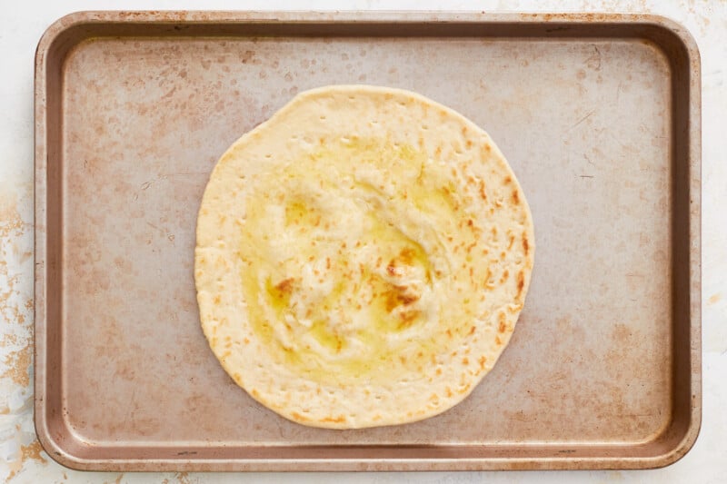olive oil spread over a premade pizza crust.