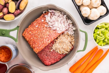 the ingredients for a meatloaf are in a pan on a table.