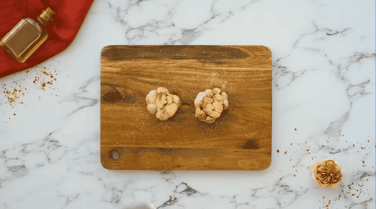 garlic cloves on a cutting board