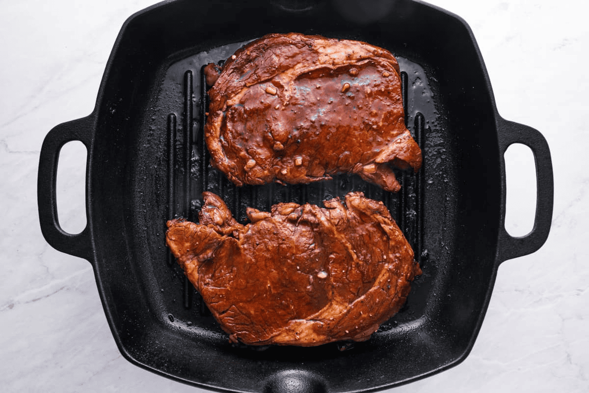 Cooking the steak in a cast iron pan.