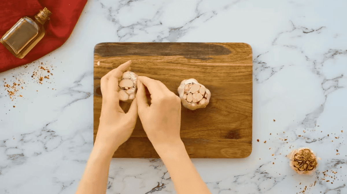 garlic cloves on a cutting board