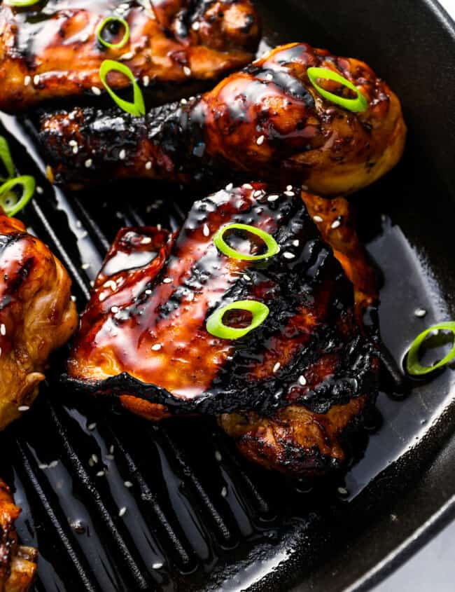 close up view of korean bbq chicken on a grill pan.