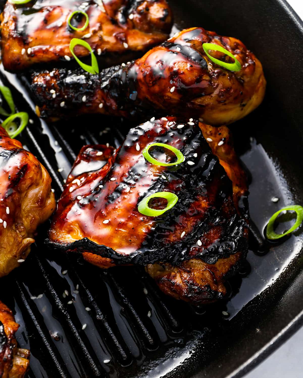 close up view of korean bbq chicken on a grill pan.