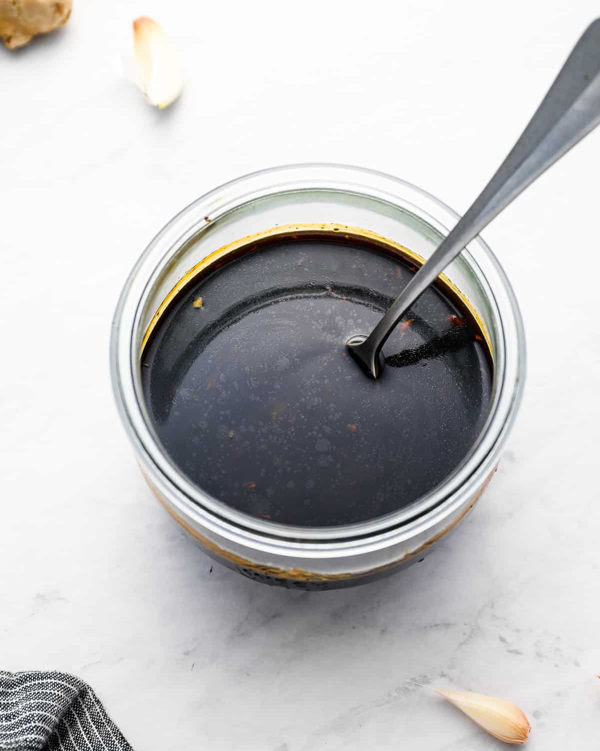 three-quarters view of korean barbecue sauce in a glass bowl with a spoon.