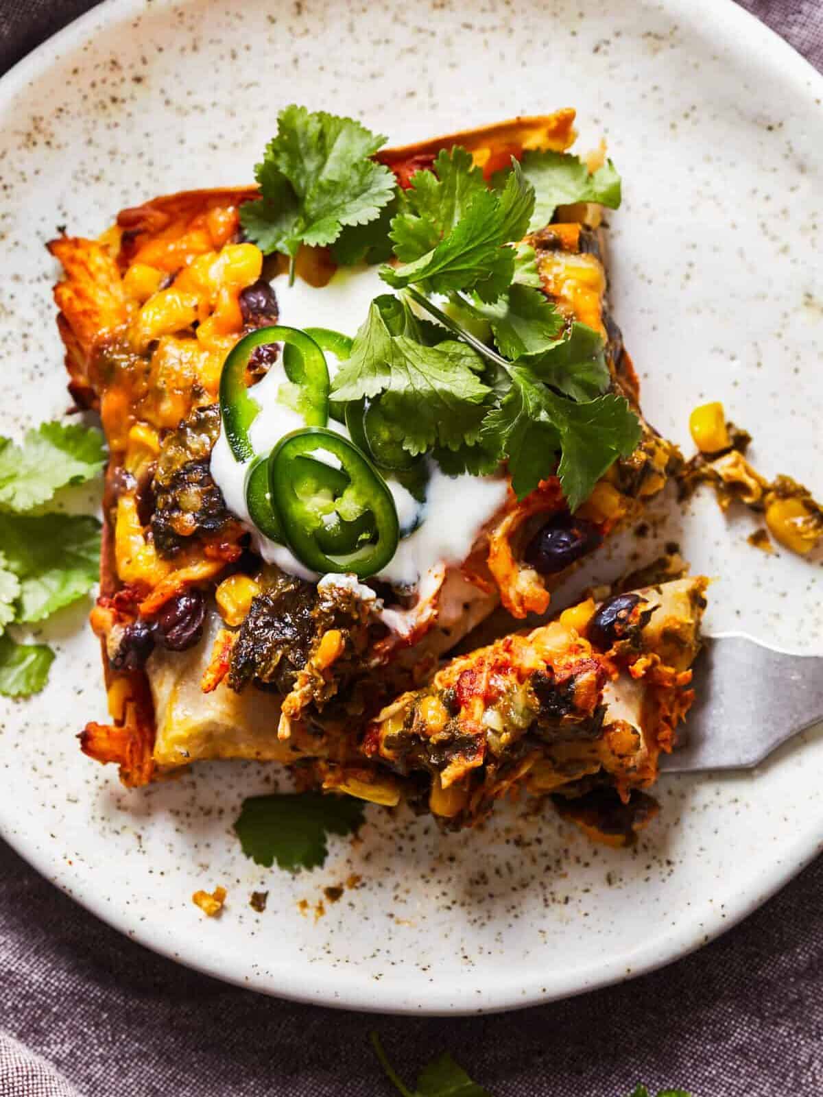 slice of mexican lasagna on a plate.