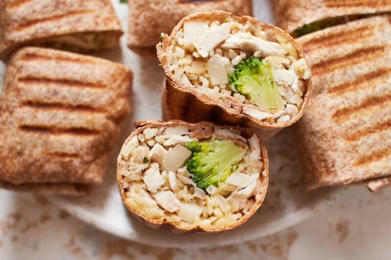 closeup overhead view of a halved chicken ranch wrap upturned to show the filling.