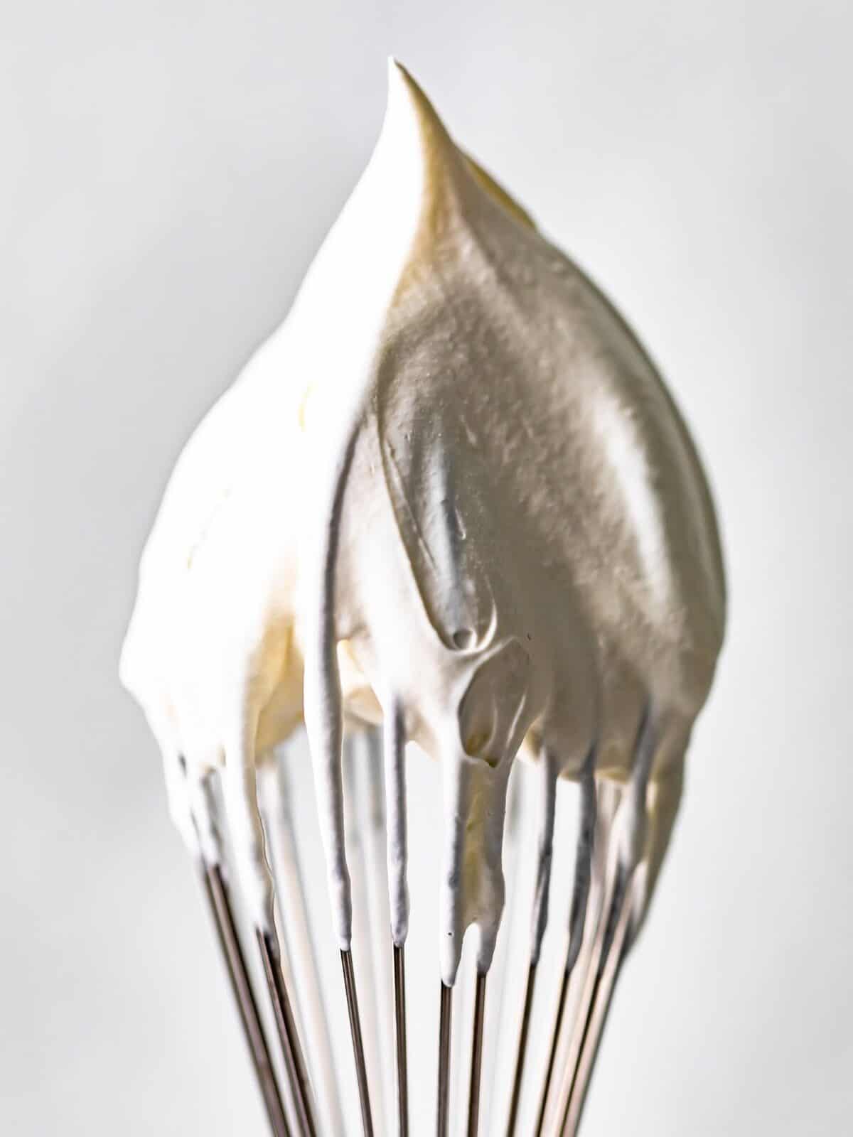 a whisk with whipped cream