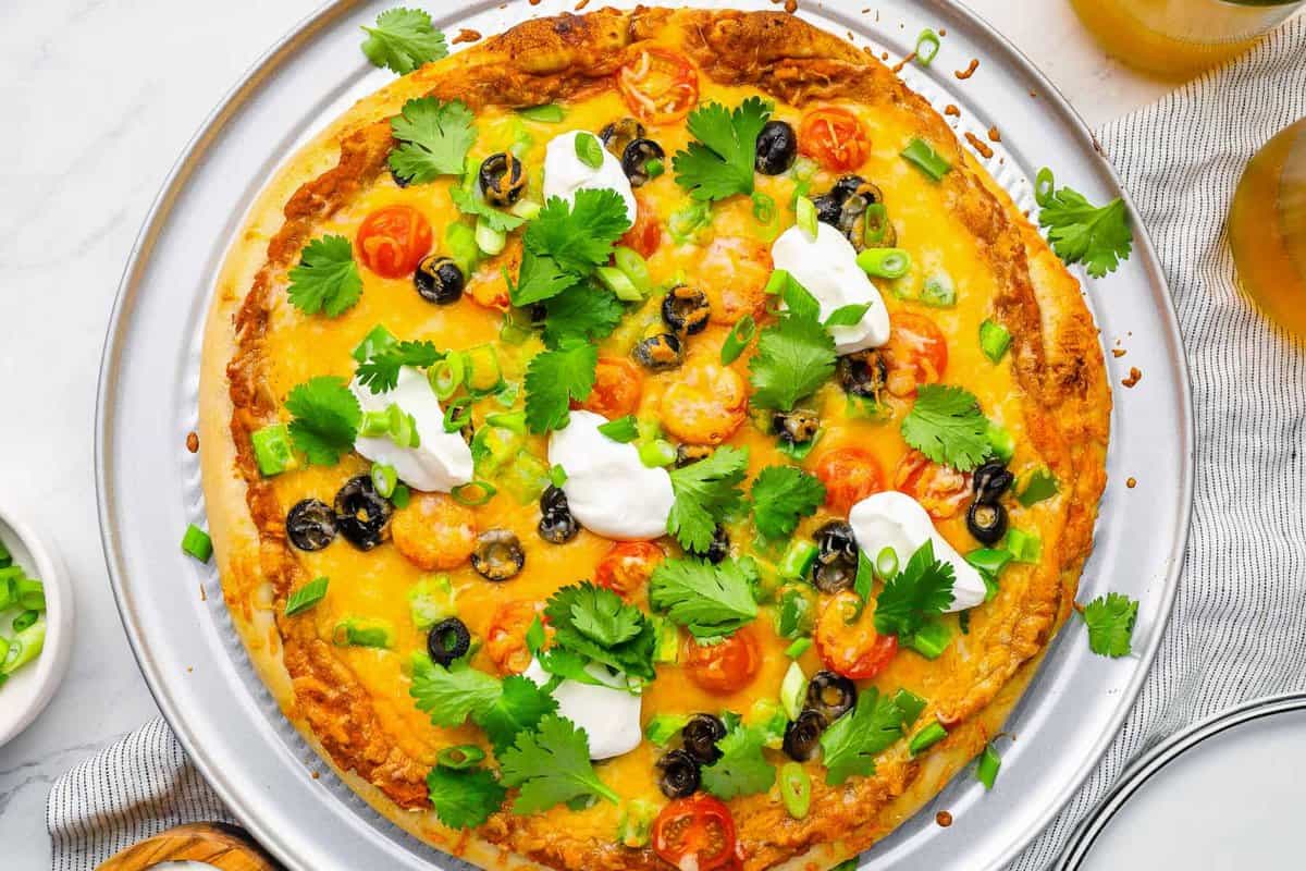 overhead view of taco pizza on a pizza pan.