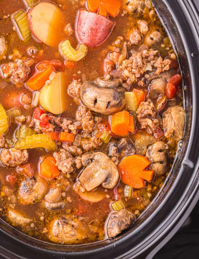 a crock pot full of meat and vegetables.