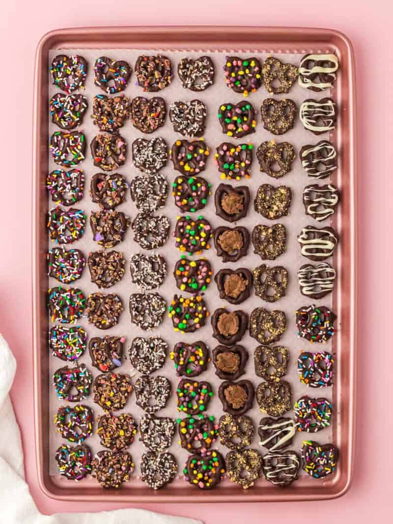 overhead image of chocolate covered pretzels on a baking sheet