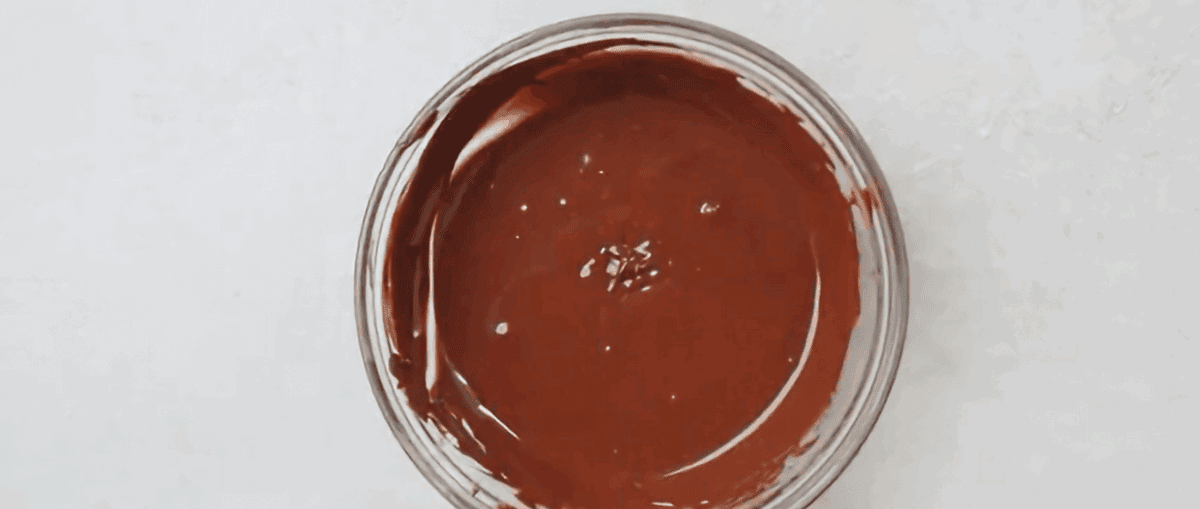 Melted chocolate in a glass bowl.