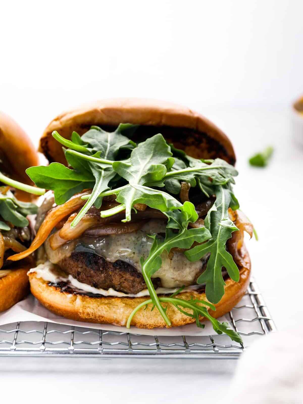 front view of a mushroom Swiss burger stuffed with arugula