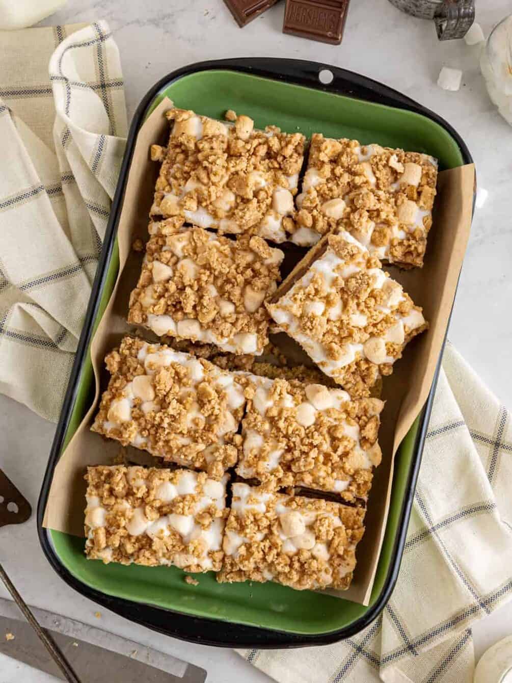 overhead view of cut smores bars in a rectangular green serving dish.