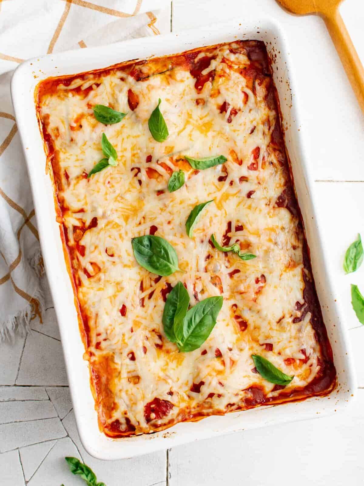 overhead view of zucchini ravioli in a white rectangular baking pan.